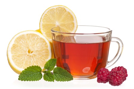 Glass cup with tea and raspberry isolated on a white の写真素材