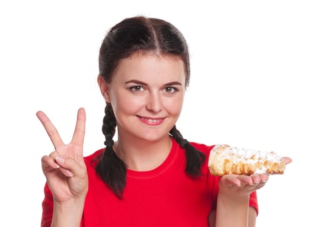 Pretty young girl with cake isolated on white 
