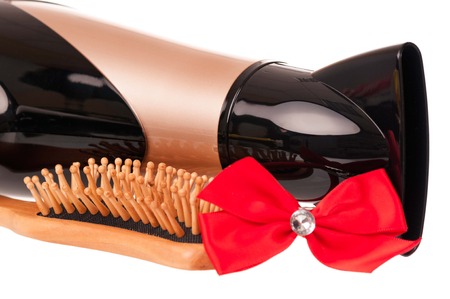 Hair dryer with hair accessories over white close-upの写真素材