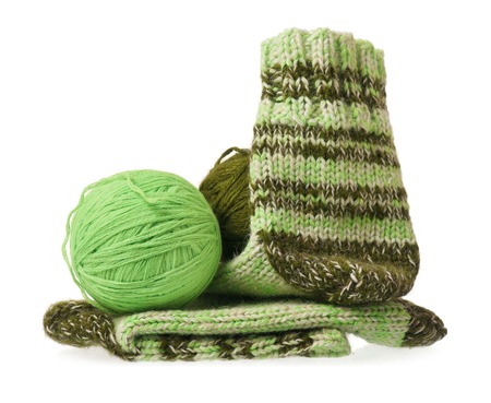 Knitted warm socks with yarn threads over white の写真素材