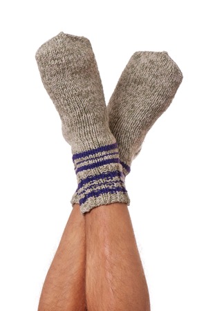 Knitted socks on the man feet isolated on white の写真素材