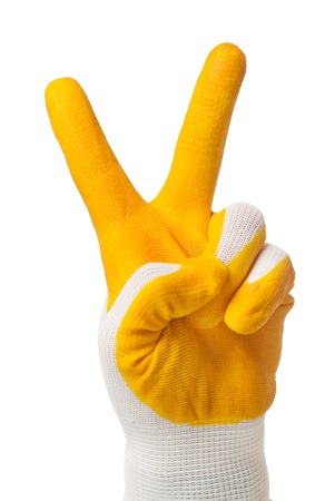 Woman hand in a protective glove shows victory gesture isolated on white backgroundの写真素材