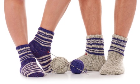 Pair of man and woman in the knitted socks over white backgroundの写真素材