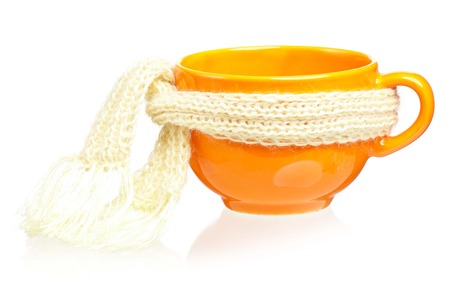 Empty cup with warm knitted scarf isolated on white の写真素材