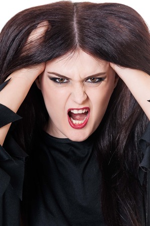 Portrait of young violent girl-witch over white の写真素材