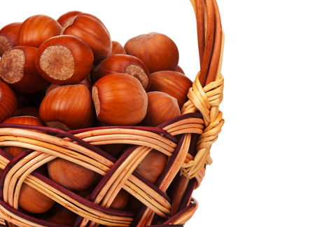 Ripe filberts on a wicker basket isolated on white backgroundの写真素材