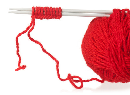 Knitting spokes with a ball of woolen threads isolated on white backgroundの写真素材