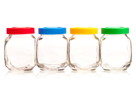 Empty glass cans with bright lids isolated on white backgroundの写真素材