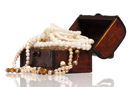 Vintage wooden chest with pearl necklaces isolated on white backgroundの写真素材