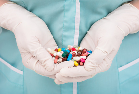 Close-up of female doctor's hand holding pills for his patientの写真素材