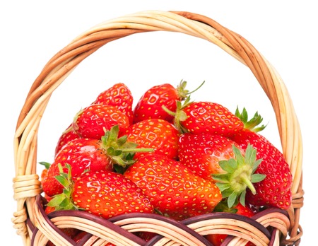 Ripe sweet strawberries in the wicker basket isolated on white backgroundの写真素材