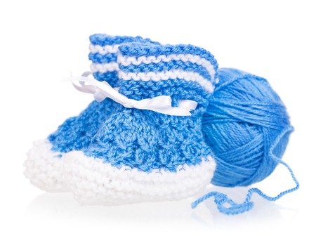 Cute little bootee with acrilic thread isolated over white backgroundの写真素材