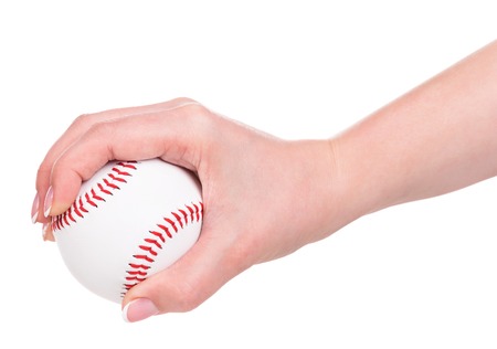 Young female hand holding baseball ball isolated over white backgroundの写真素材
