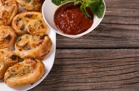 Tasty barmy rolls with stuffing over old wooden surfaceの写真素材