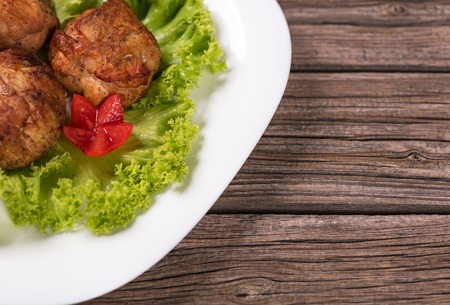 Delicious baked cutlets over wooden surface with copy space for your textの写真素材
