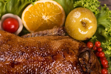 Baked young duck with vegetables on the green lettuce leavesの写真素材
