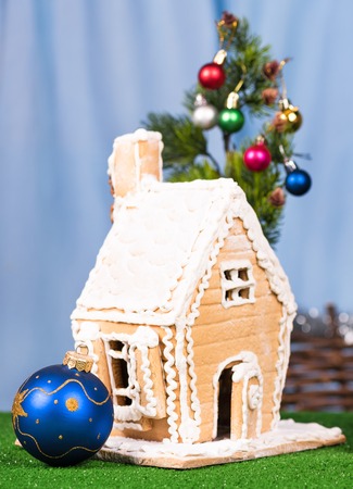 Gingerbread lodge with Christmas gifts and toys over blue backgroundの写真素材