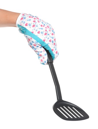 Kitchen utensil in woman hand isolated over white backgroundの写真素材