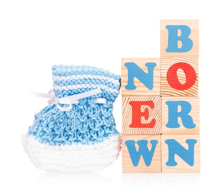 Bright cute little bootee with playing cubes isolated over white backgroundの写真素材