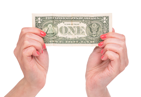 Female hands holding one dollar isolated over white backgroundの写真素材