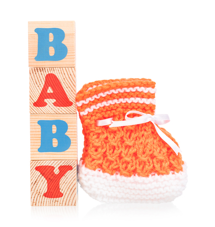Bright little bootee with playing cubes isolated over white backgroundの写真素材