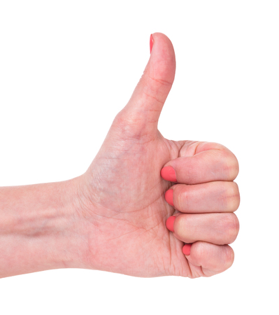 Female hand shows a gesture with thumb up isolated over white backgroundの写真素材