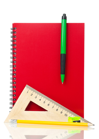 School exercise-book with stationery isolated over white backgroundの写真素材