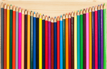 Bright colorful pencils for drawing over wooden surfaceの写真素材