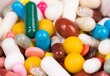 Close-up of female doctor's hand holding pills for his patientの写真素材