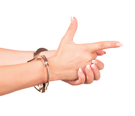 Young female hands with handcuff isolated over white backgroundの写真素材