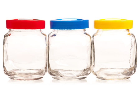 Empty glass cans with bright lids isolated on white backgroundの写真素材