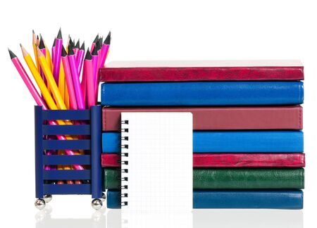School exercise-books with pencils isolated on white backgroundの写真素材