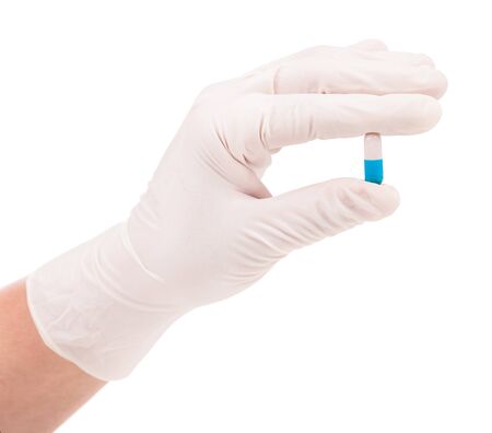 White pill in the woman hands isolated over white backgroundの写真素材