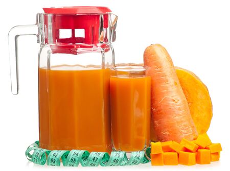 Fresh vegetables juice with tape measure isolated on white backgroundの写真素材