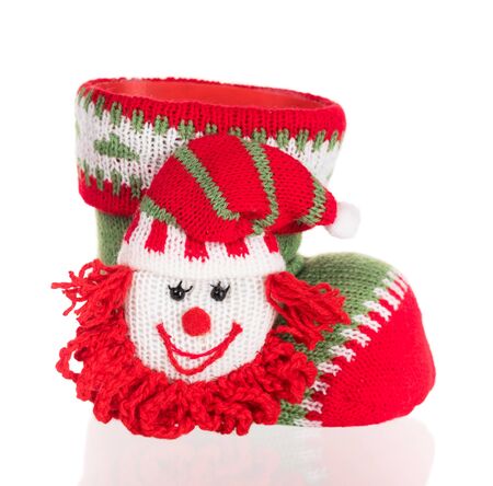 Bright knitting shoe with elf heaf for Christmas eve isolated over white backgroundの写真素材