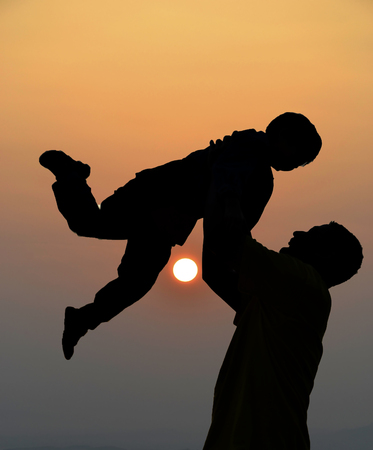 very nice silhouette of father and sonの写真素材