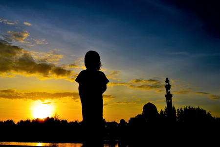 silhouette of kids during sunset with mosque backgroundの写真素材