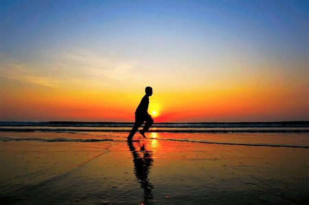silhouette of man running on the beachの写真素材
