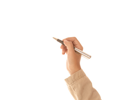 hand of a female holding a pen isolated on white background.の写真素材