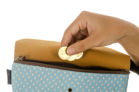 Woman hand put money in purse isolated on white backgroundの写真素材