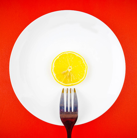 Lemon slices in white plate with spoon