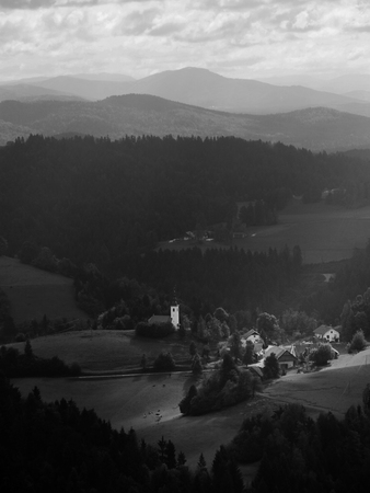 Small town and church have sun ray shining on them.の写真素材