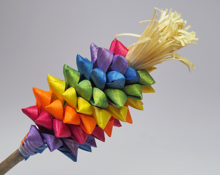 Bouquet made of colorfully dyed wood reeds tied to a stick on an plain background. The bouquet is used as decoration during Easter Sunday.の写真素材