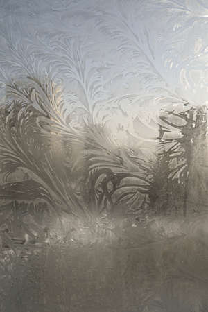 Beautiful ice pattern on the winter glass, natural texture. Miracles, winter, frost and cold.の写真素材