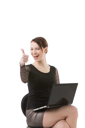 Woman with laptop giving thumb upの写真素材