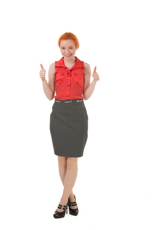 Happy stylish redhead woman standing looking at the camera giving a double thumbs up gesture of approval and success isolated on whiteの写真素材