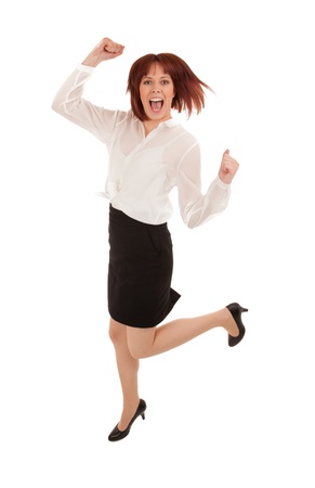 Excited woman leaping for joy as she celebrates good news leaping and cheering, isolated on whiteの写真素材