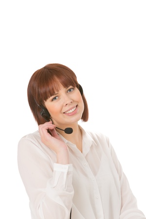 Smiling attractive young call centre operator or receptionist talking on a headset isolated on whiteの写真素材