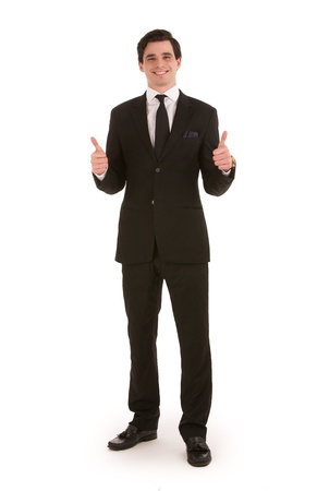 Successful businessman standing facing the viewer with a cheerful smile giving a double thumbs up of approval isolated on whiteの写真素材
