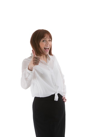 Playful young business woman giving a thumbs up of approval and winking, isolated on whiteの写真素材